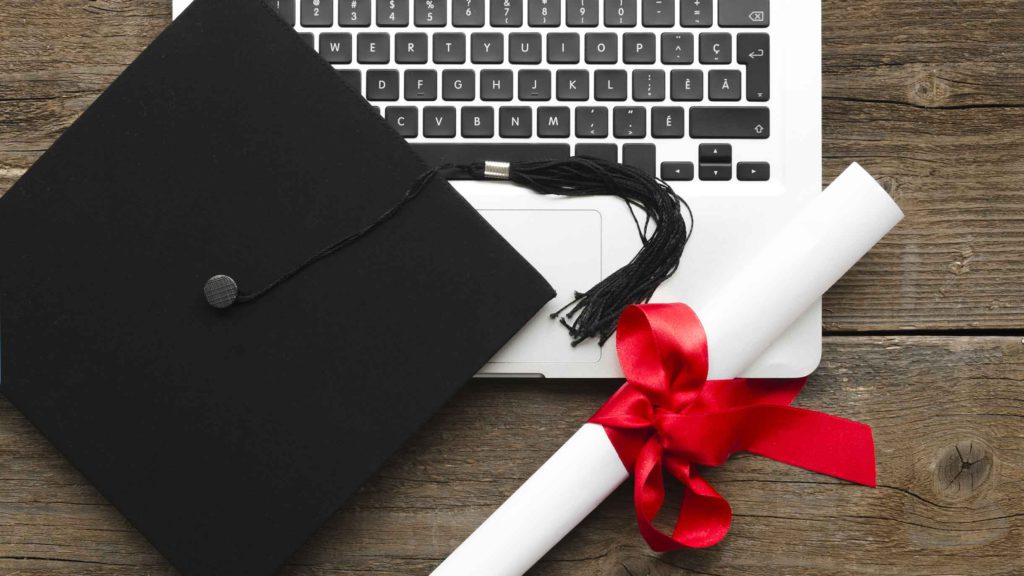 Diploma and Mortarboard with Laptop